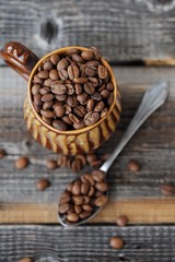 Roasted coffee beans in a clay mug 