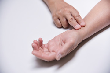 Asian Senior Female checking her pulse.
