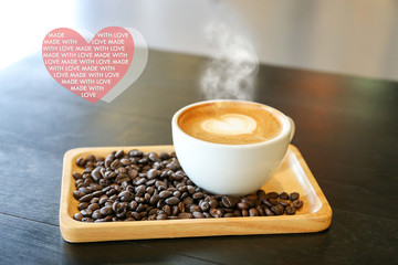 Inspirational positive quote “ Made with love” with heart shape latte coffee background.