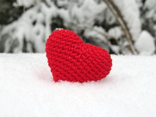 Love heart. Knitted red heart with snowflakes