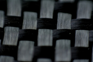 Black carbon fiber composite close up macro view background