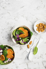 Lunch salad with spinach, sweet potato, red cabbage and young cheese with nuts of almonds..