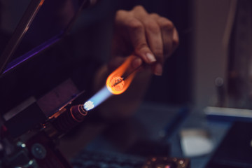 Process of manufacturing costume jewelery from Venetian glass.