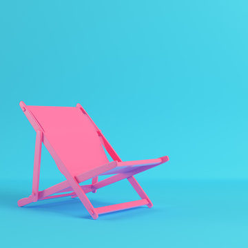 Pink Beach Chair On Bright Blue Background In Pastel Colors