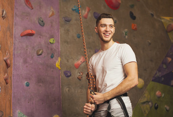 Young man preparing for climbing