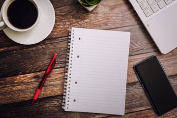 Top view 2018 goals list with notebook, cup of coffee on wooden desk