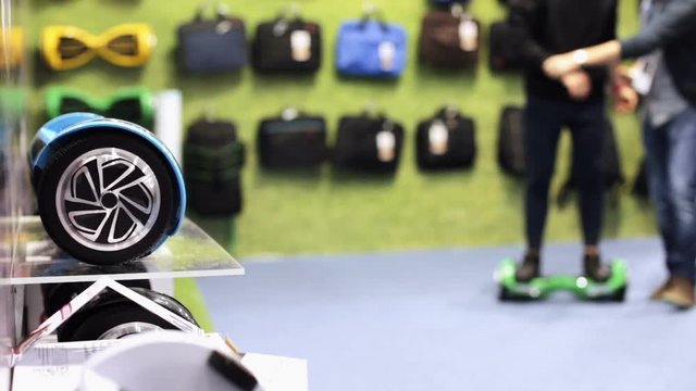 A young man buys a gyroboard in a store