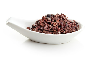 Cacao nibs in porcelain spoon