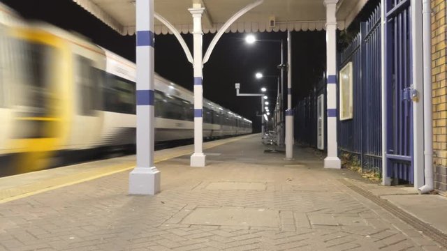 Time lapse. Arrival of the train to the station. London at night.