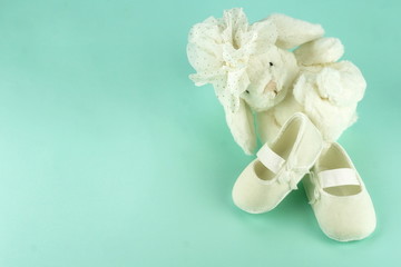 Waiting for baby. white ballet shoes for newborn and bunny on a pastel blue background. copy space