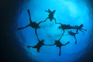 Fotobehang Scuba divers swim over coral reef © Richard Carey