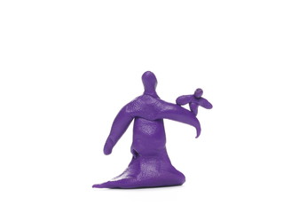 Purple plasticine in man sculpture holding pigeon shape isolated on white background