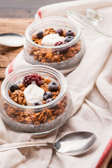breakfast with chia, yoghurt and granola on a wooden table