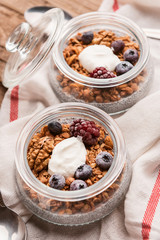 breakfast with chia, yoghurt and granola on a wooden table