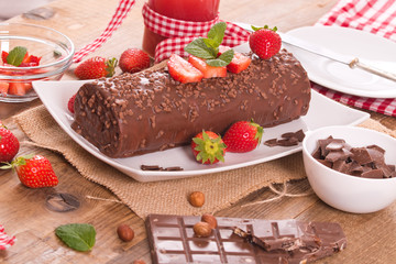 Chocolate roll with hazelnuts and strawberries. 