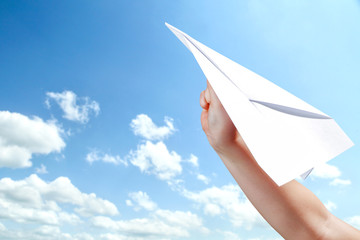 hand with airplane of paper 