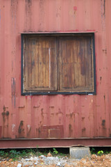 The old walls are made of metal sheet, painted red. And wooden windows.