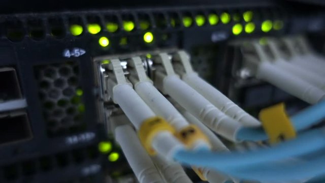 Optical server. Commutator. flashing lights. Optical fiber. Video IP Gateways. Audio. Severs computer in a rack at the large data center. Rack Mounted Servers. Close-up