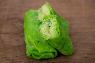 Dadar Gulung / rolled pancake typical Indonesian coconut pancake on table.