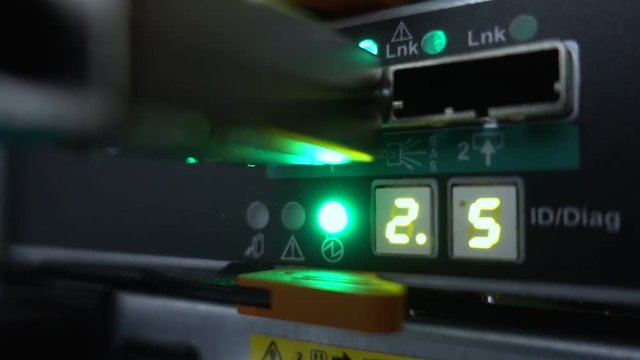 Flashing lamps. Fiber Optical connector interface. Rack Mounted Servers In A Server Room, Server rack link cable. - Powered by Adobe