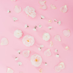 Pattern white white roses on pink background. Flat lay, top view. Pastel background.