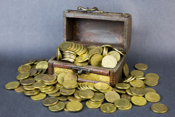 An old chest with money. Chest full of jewelry of metal coins and other treasures
