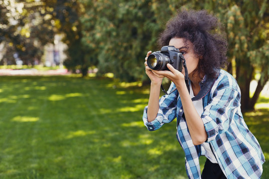 Young woman taking pictures outdoors