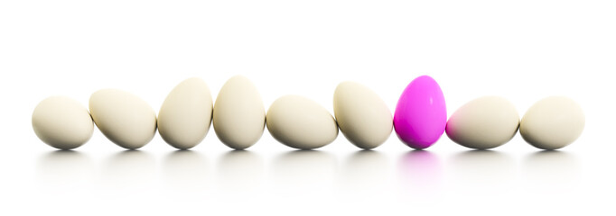 a row of easter eggs one dyed in pink