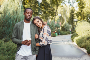Happy couple hugging in park copy space