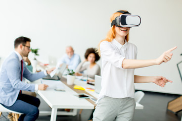 Young woman using virtual reality simulator in the office