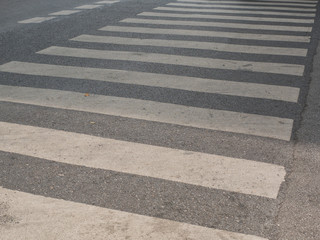 Zebra cross walk on asphalt road.