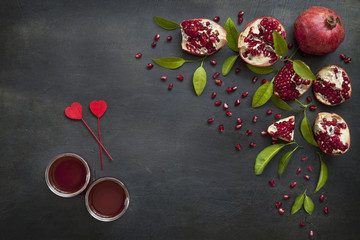 Pomegranate and freshly squeezed pomegranate juice on a vintage background. Top view, background.