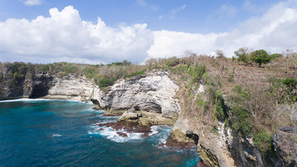 Fototapeta na wymiar Seascape, rocky coast, ocean, blue sea, waves, Nusa Penida, Indonesia. Aerial view Ocean with waves and rocky cliff. Travel concept