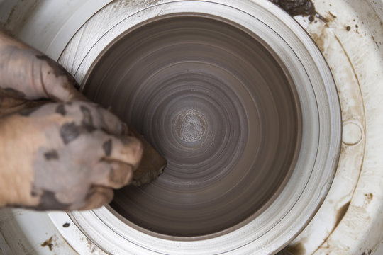 Artist makes clay pottery on a spin wheel