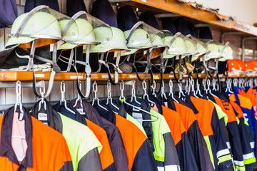 Helmets and uniforms in locker room of fire fighters