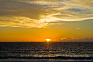 Fototapeta premium A beautiful sunset with clouds at Patok Beach on Racha Island, Phuket, Thailand.