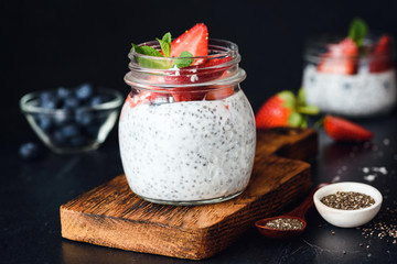 Chia pudding with fresh berries in a jar. Selective focus. Cleansing, dieting, healthy eating, fitness menu concept
