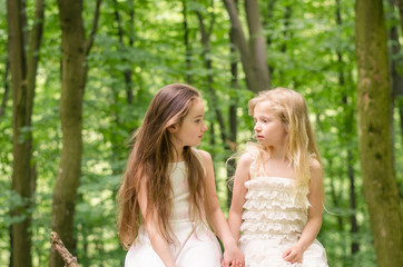 Fototapeta premium two beautiful children sitting in meadow