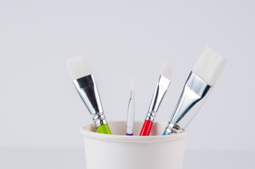 paint brushes in a cup