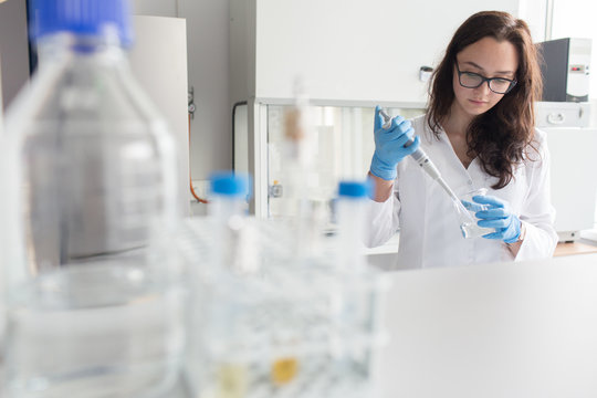 Woman holding flask in lab