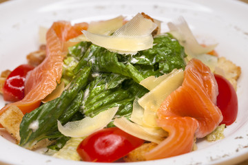 Obraz na płótnie Canvas Caesar Salad plate with salmon