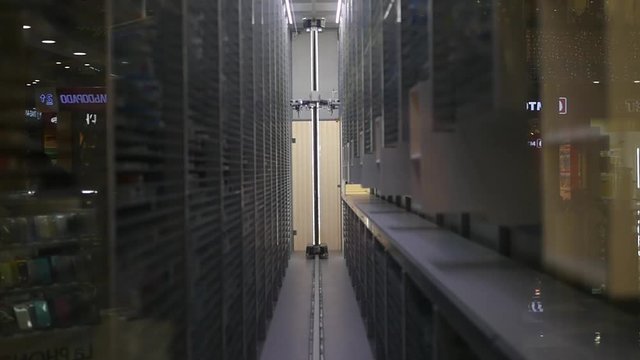The robot travels around the warehouse and picks up the goods from the stands