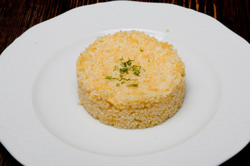 Risotto of wheat on a white plate