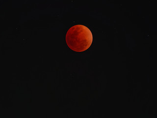 Super blue blood moon with total lunar eclipse over dark sky background