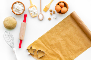 Prepare to baking. Dough ball near cookware on white background top view. Mock up with baking paper