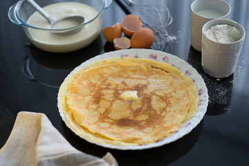 Ingredients for pancake on a black glossy background. Pancake day