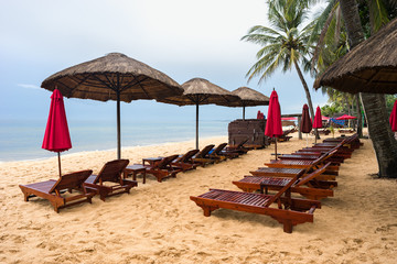 Bad cloudy weather in wet low season on Phu Quoc island.  Nobody on Long Beach. Empty sunbeds