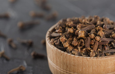 spices of cloves  in a wooden bowl