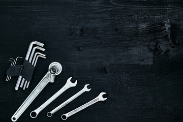 Tools for work or repair auto on black wooden background. Top view