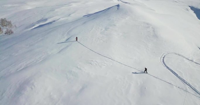Men go skitour in high snow moutains.